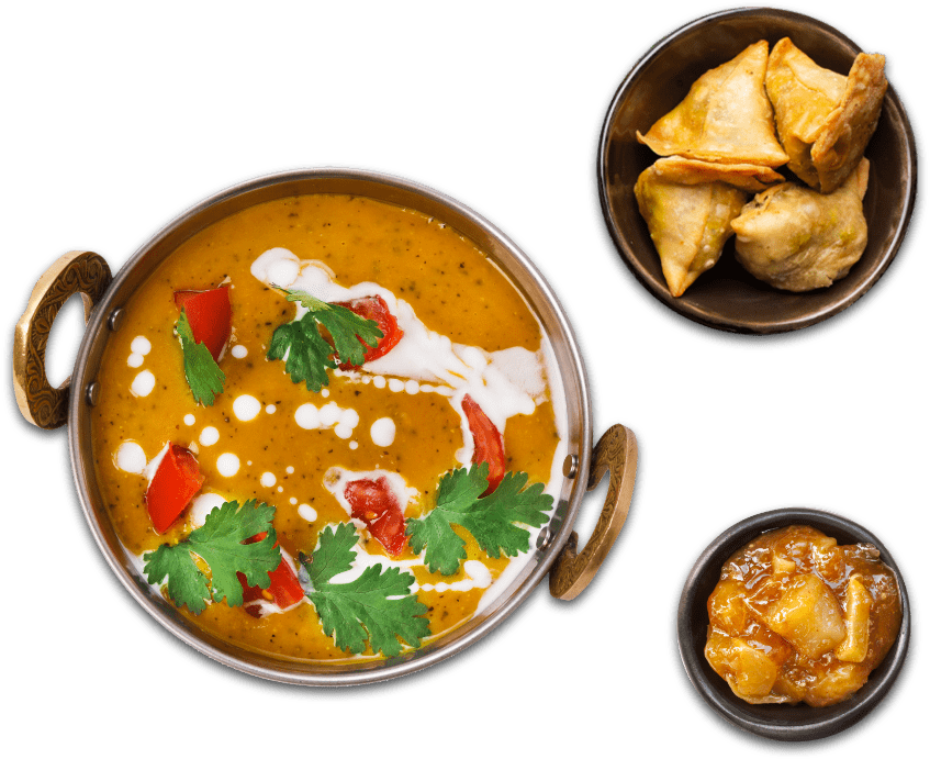 A delicious curry served with a samosa sides and a dip